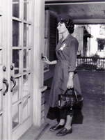 1960 photo of a woman standing at the door